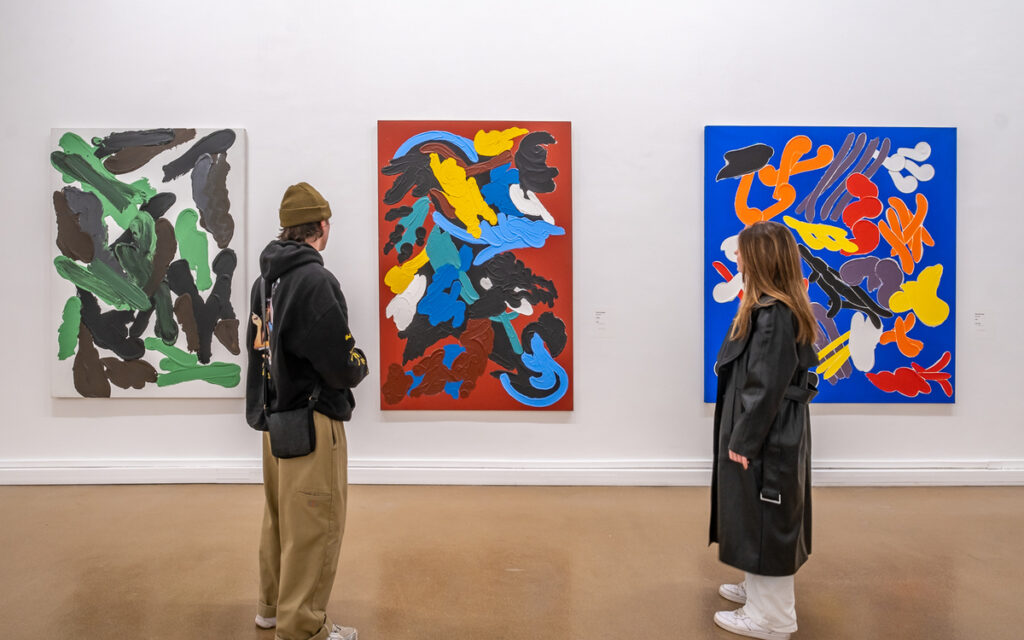 Visitors exploring a contemporary art and fashion exhibition in a Paris museum, 2025.